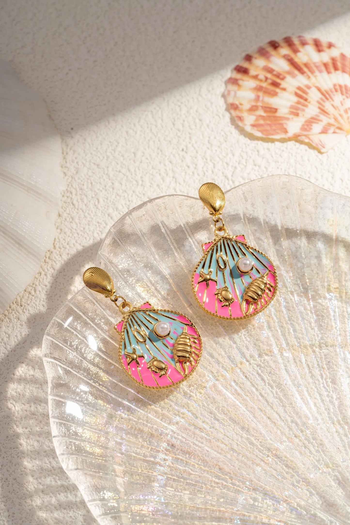 Boucle d'oreille en forme de coquillage pendante en acier rose